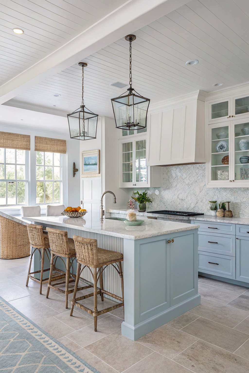 Light blue-gray island cabinets in a coastal-style kitchen.