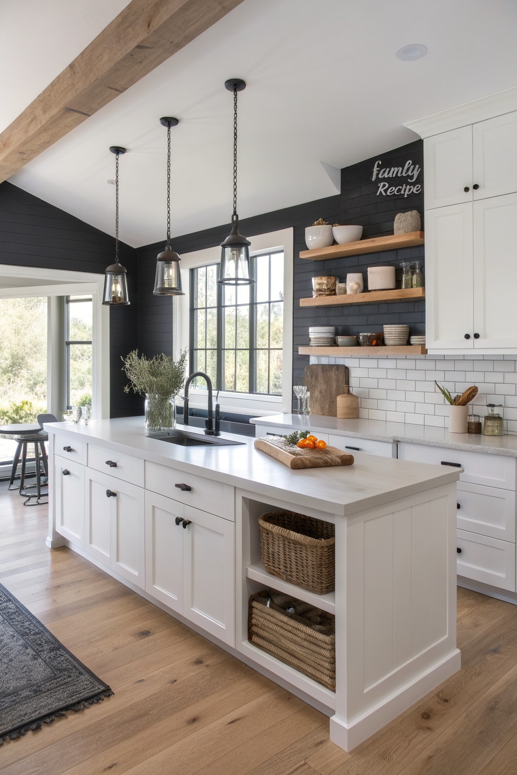 A kitchen with white cabinets against deep black walls.