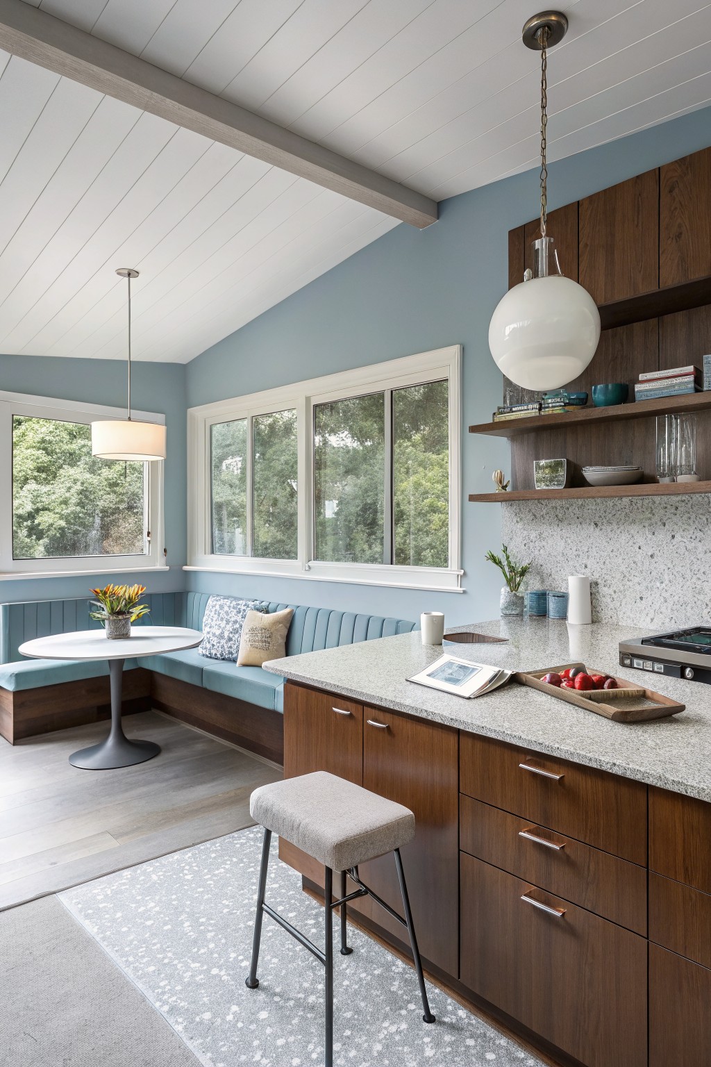 A kitchen with soft blue gray walls and wood cabinetry.
