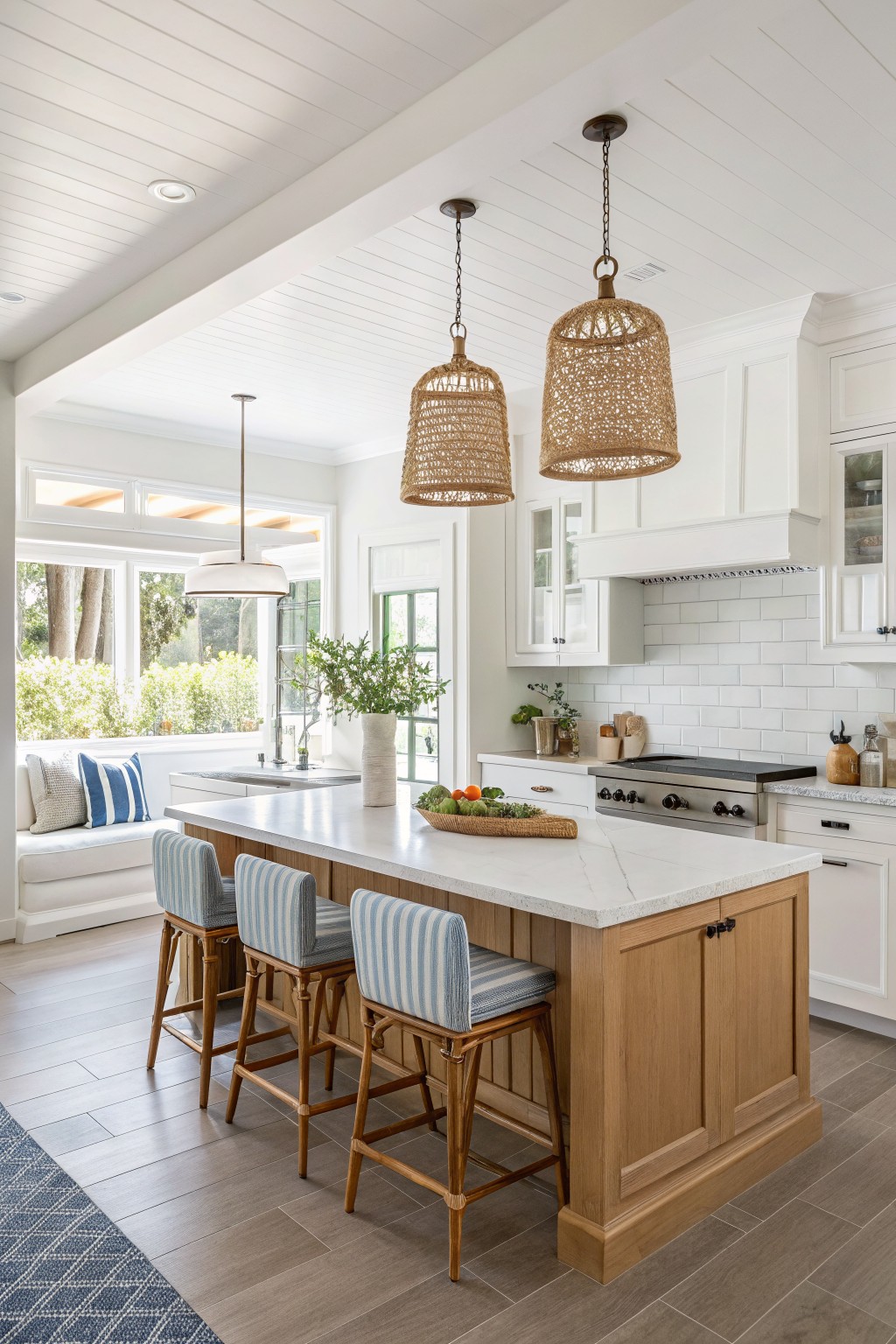 White kitchen cabinets and ceiling in a bright open space with a wood island.
