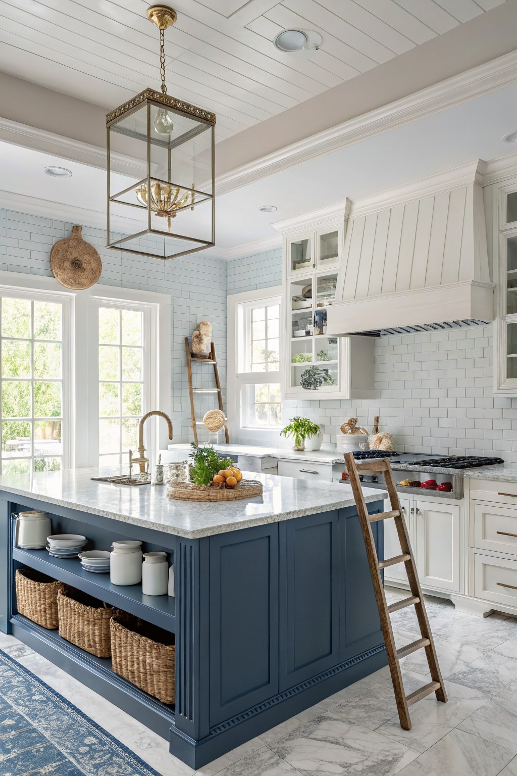 Navy blue kitchen island cabinets in a bright white kitchen.