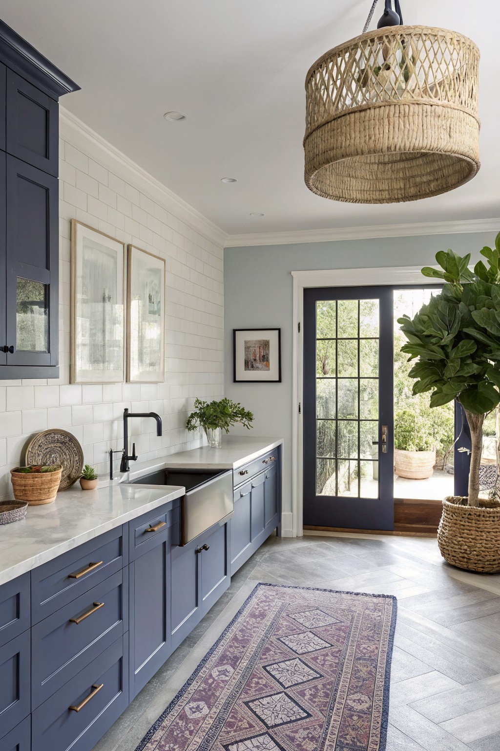 Blue gray cabinets in a kitchen with white tile and a farmhouse sink.