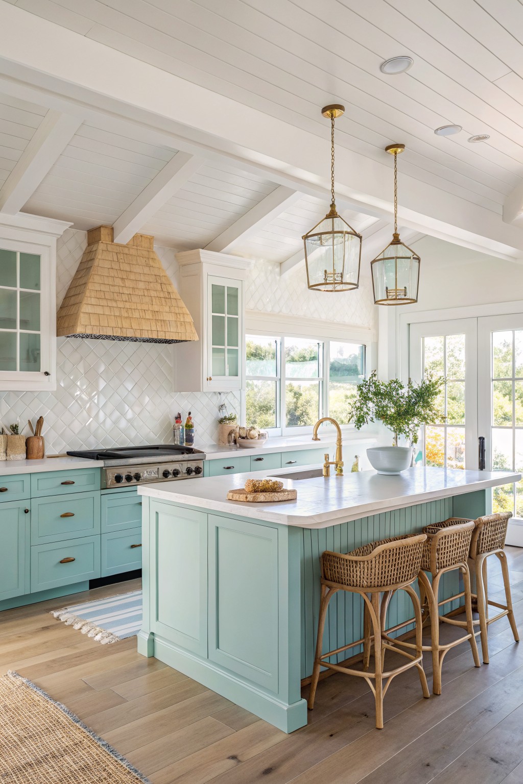 Kitchen island and cabinets painted in a soft blue green.