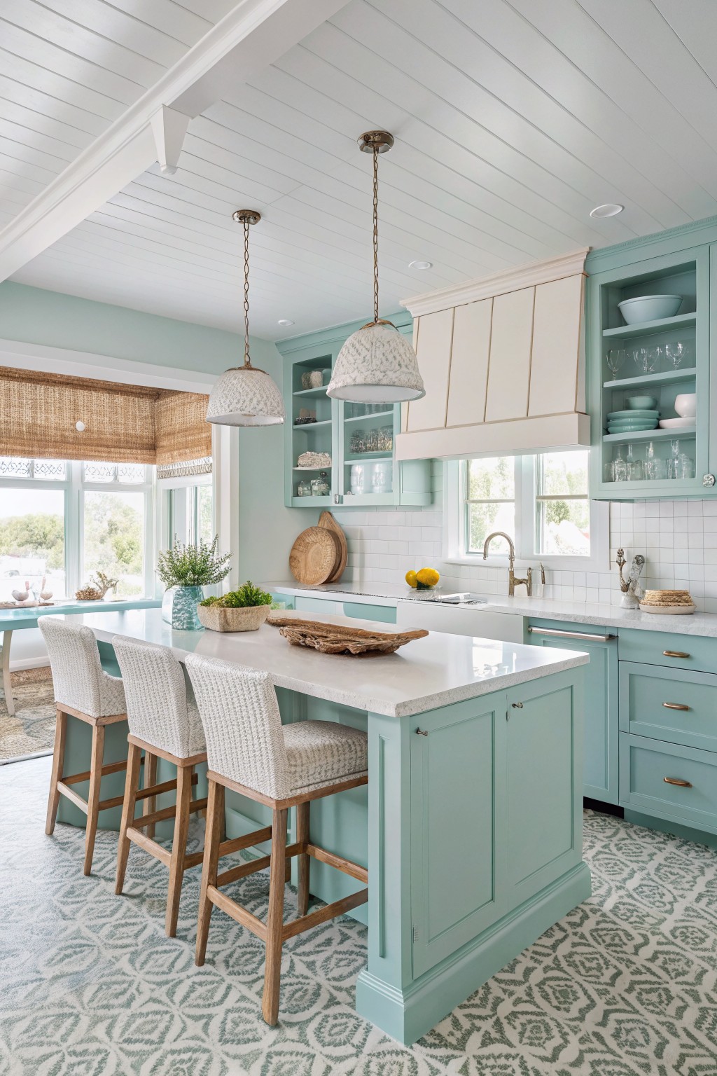Mint green kitchen cabinets paired with a white countertop and wooden bar stools.