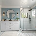 A bathroom featuring soft teal blue walls with white vanity and marble countertop.