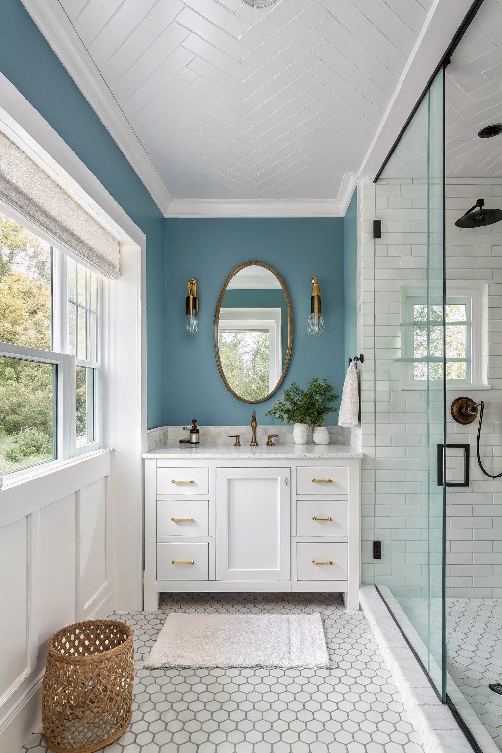 A bathroom featuring soft teal blue walls with white vanity and marble countertop.