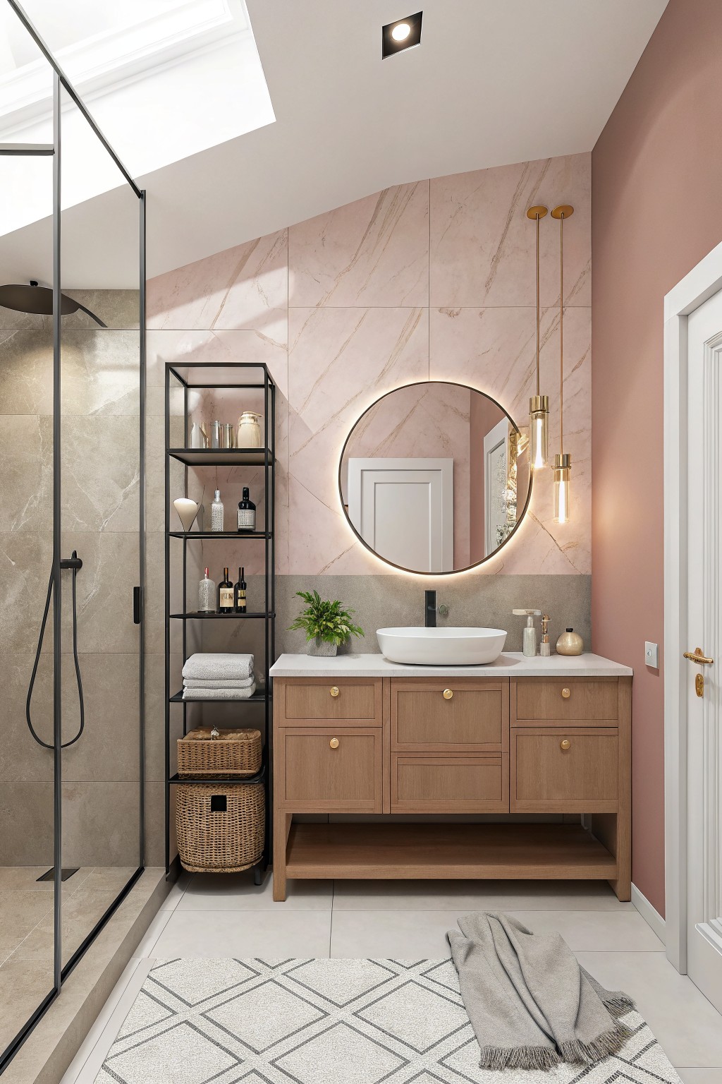 A bathroom with soft pink walls next to a wooden vanity and round mirror.