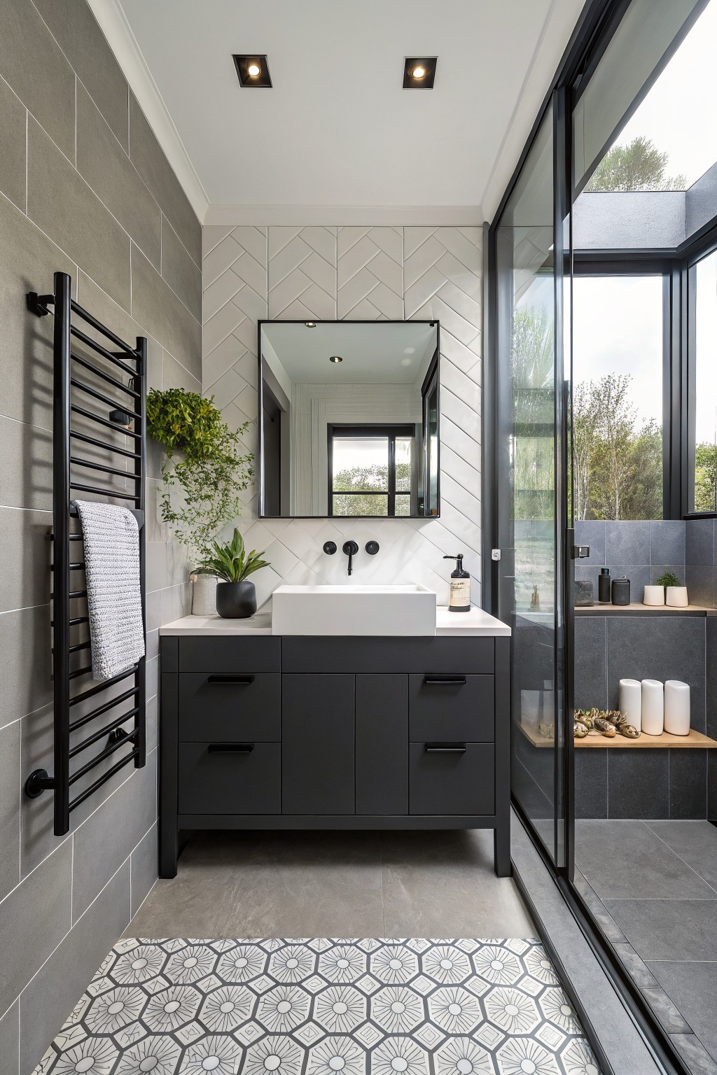 A bathroom vanity painted deep black with a white sink and gray tiled walls.