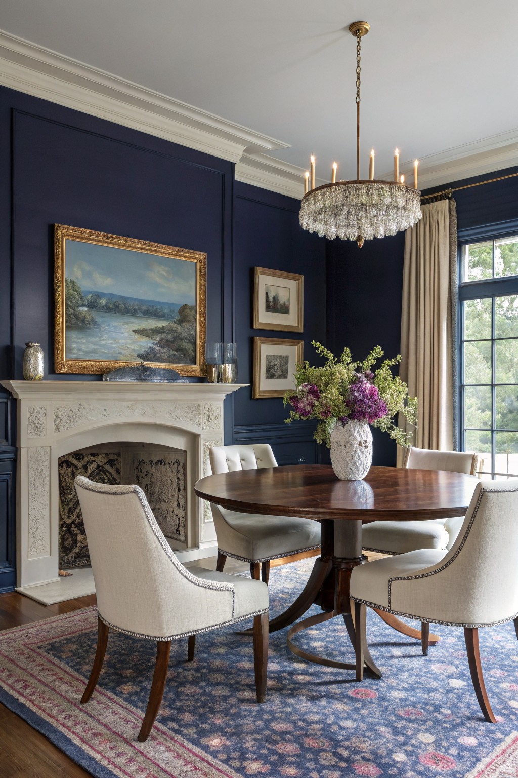 Deep navy walls in a dining room with white trim and a wooden table.