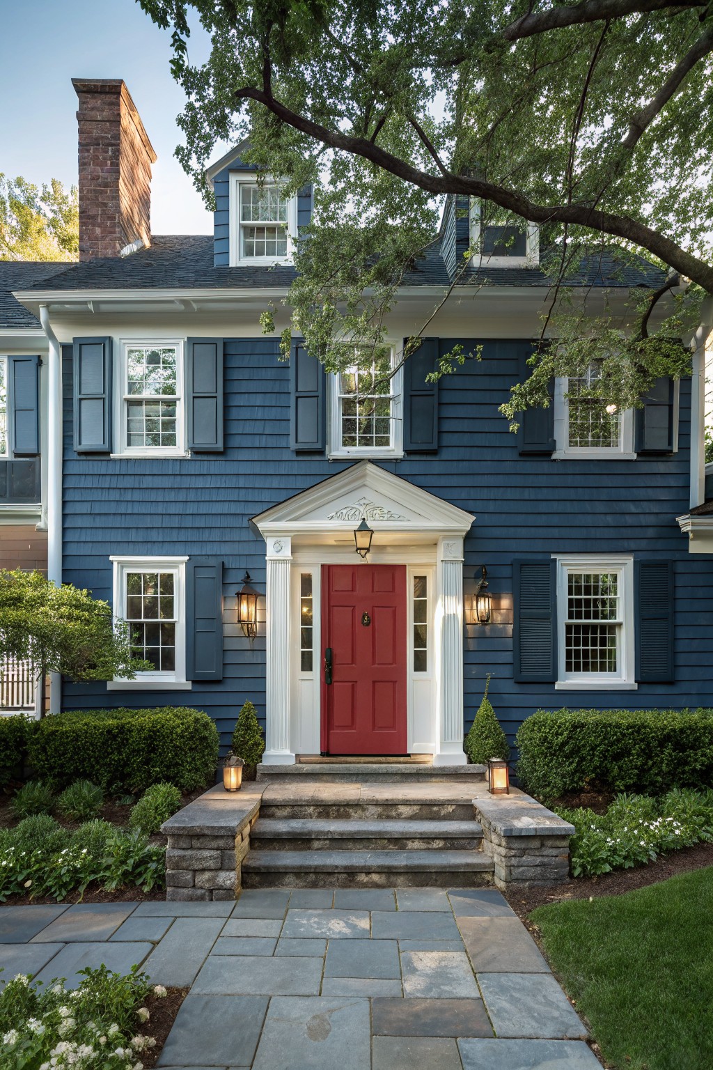 A house exterior painted in deep navy blue siding with white trim.