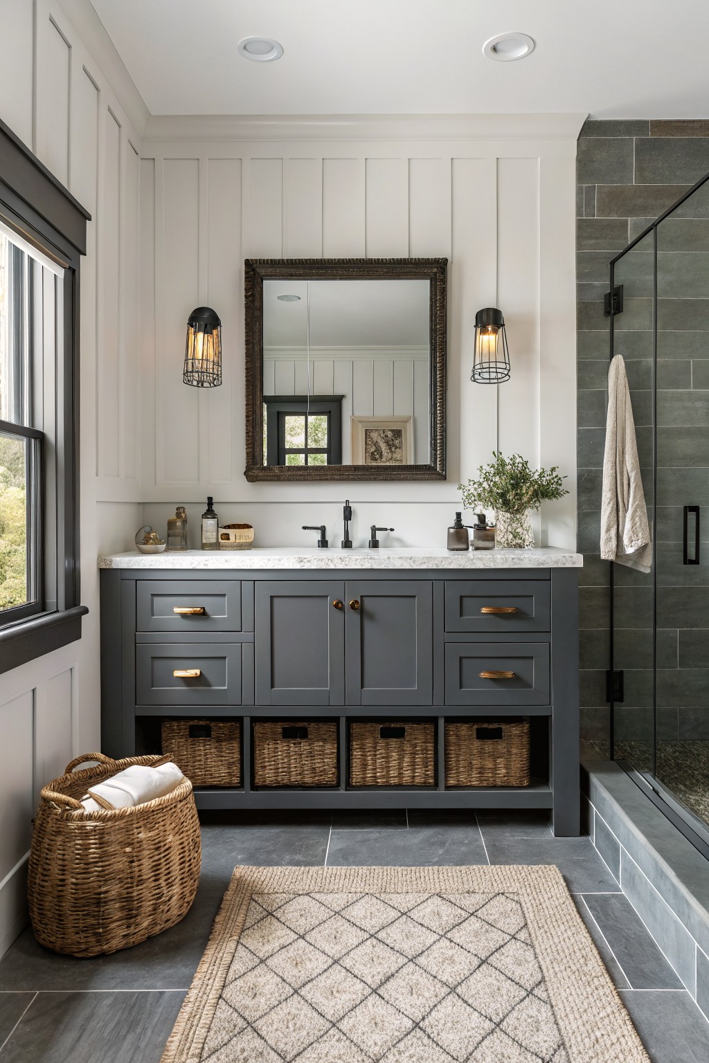A bathroom vanity painted in a deep gray color with woven storage baskets underneath.
