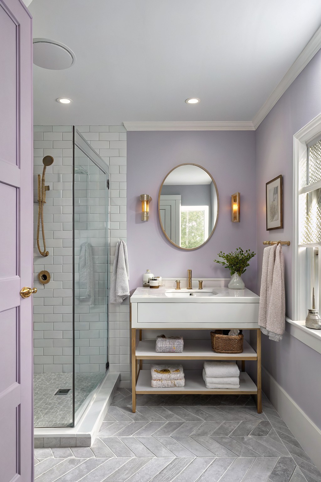 A bathroom with soft lavender walls and a white vanity.