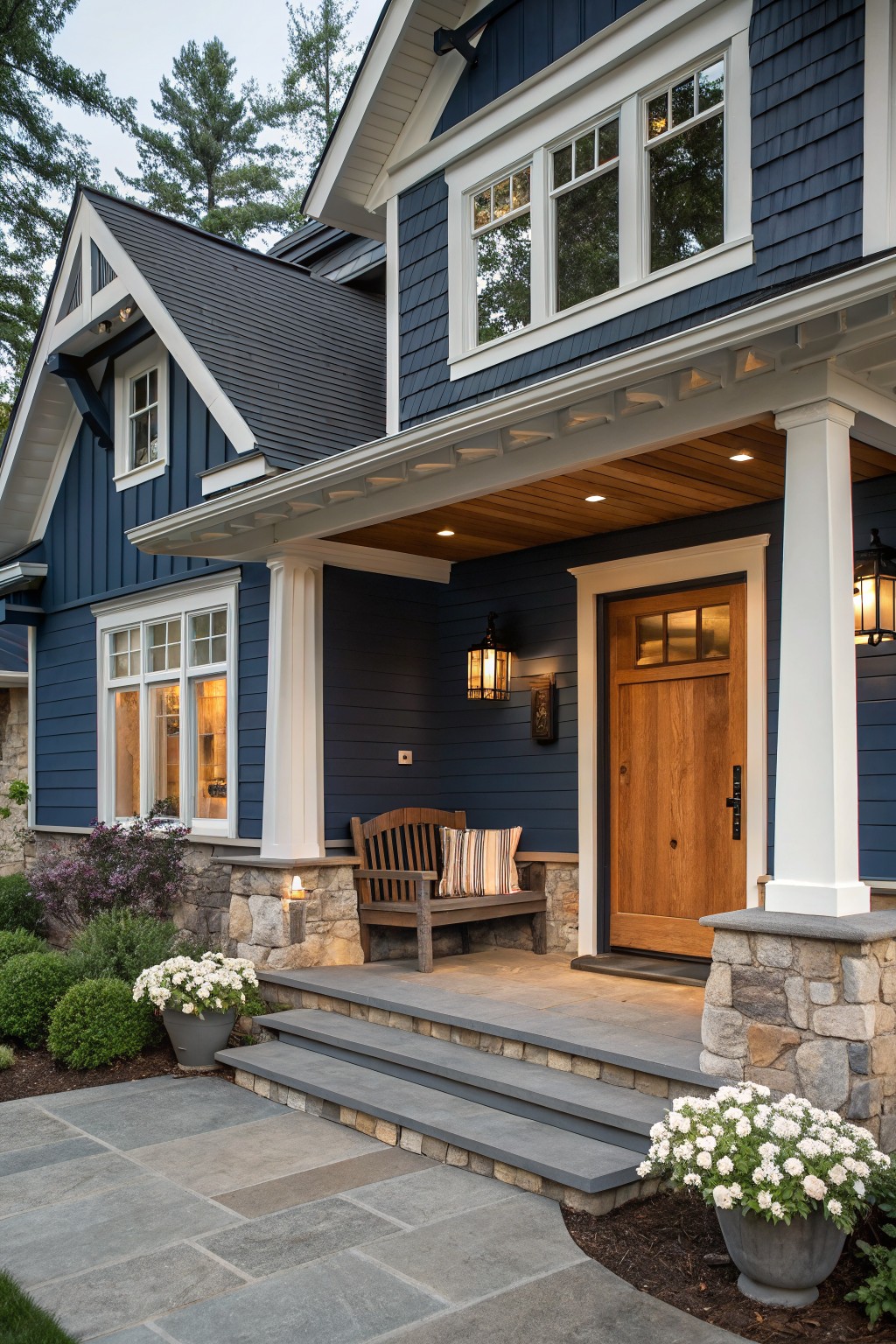 Charming blue house porch with white columns, wooden door, and stone steps