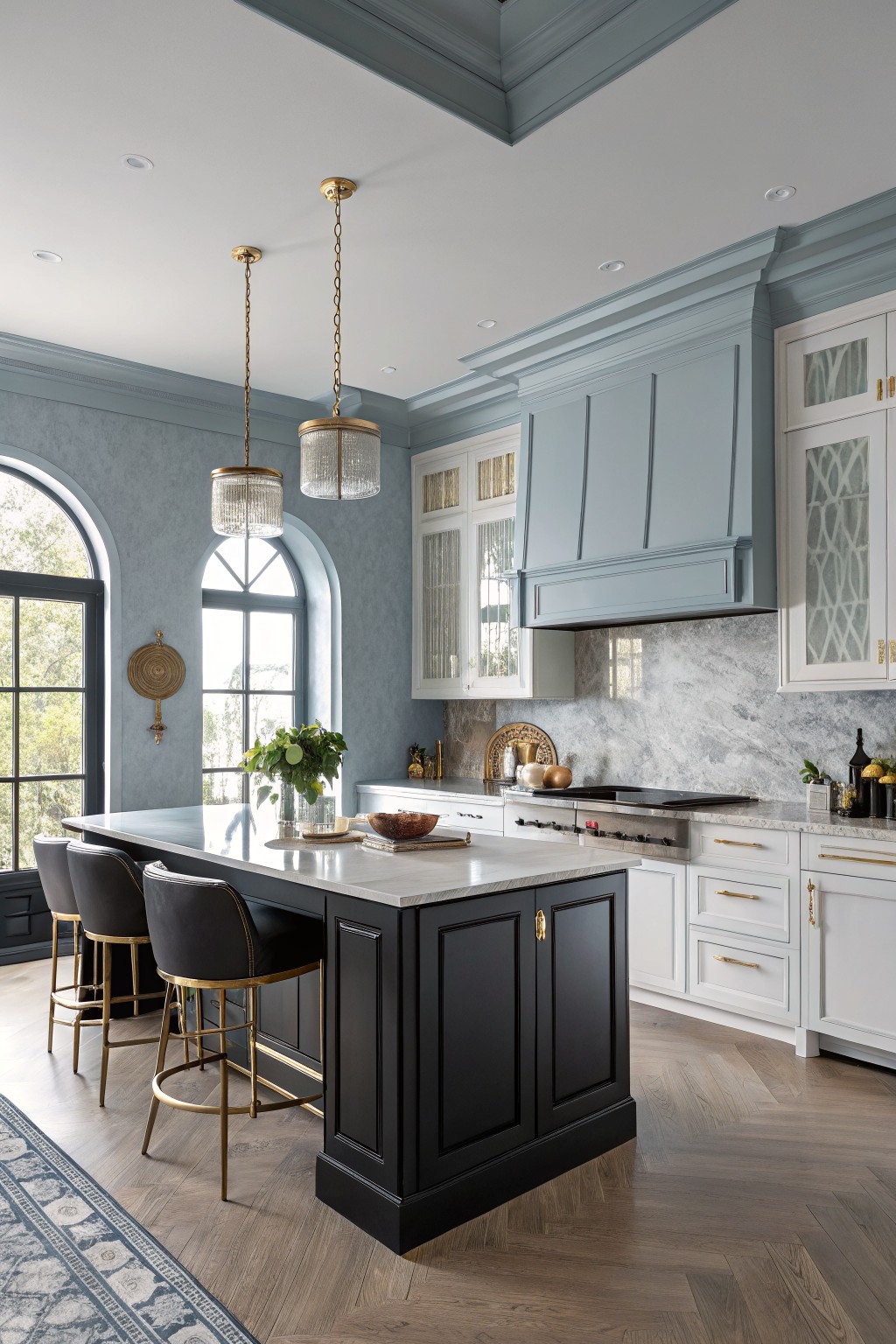Blue gray upper cabinets and walls in a kitchen with a black island.