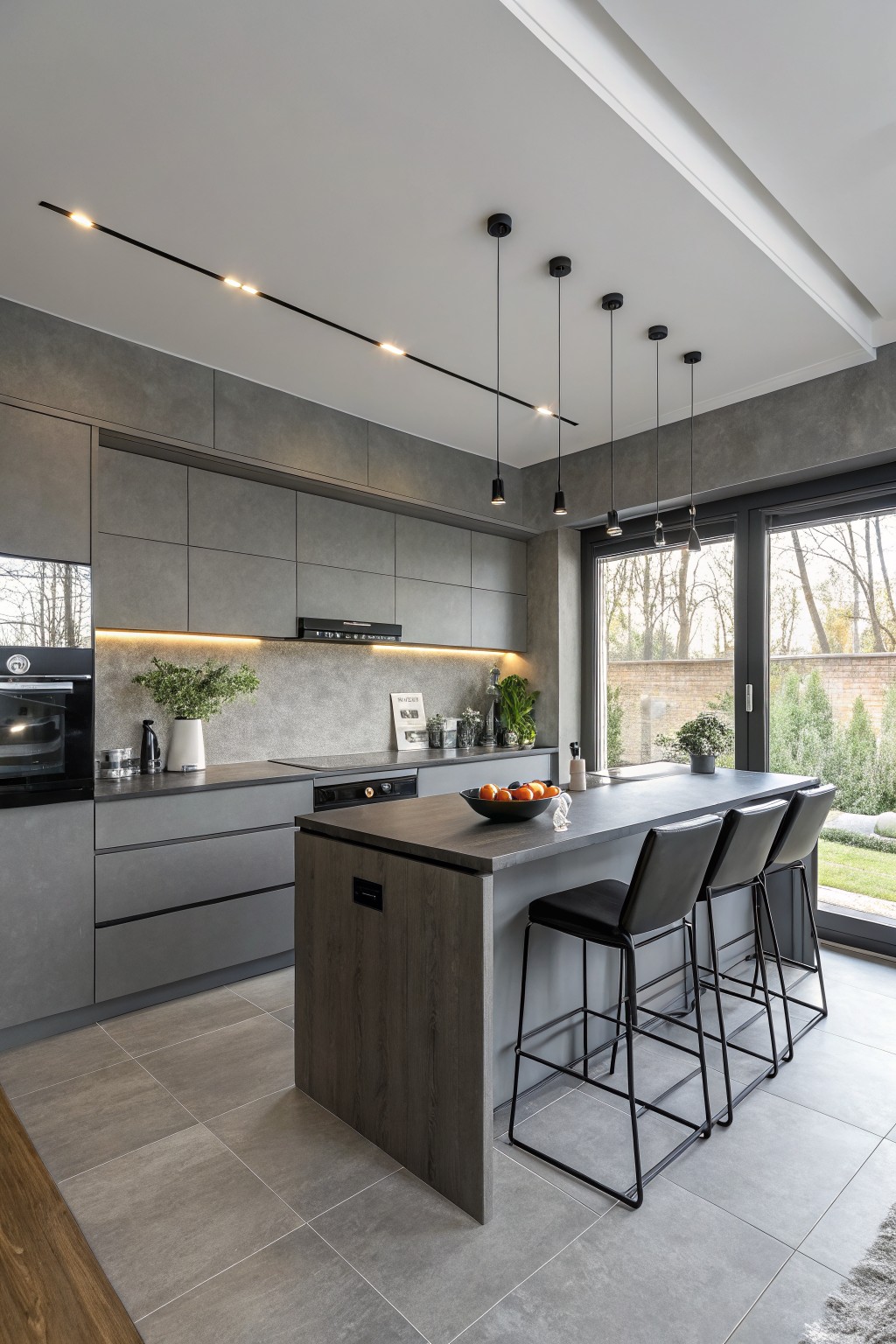 Modern kitchen with medium gray cabinets and walls.