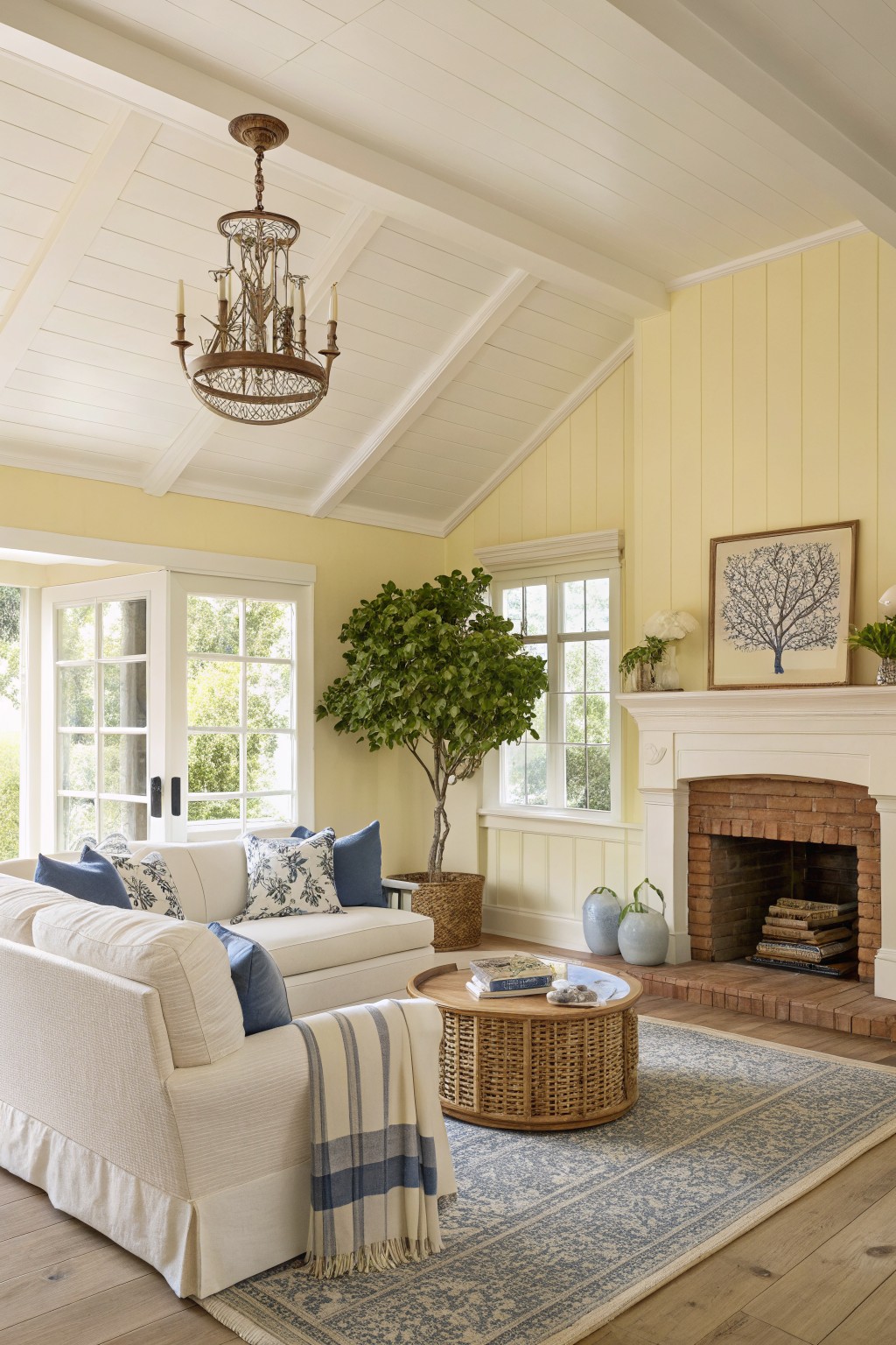 Living room walls painted a soft pale yellow with white trim and wood flooring.