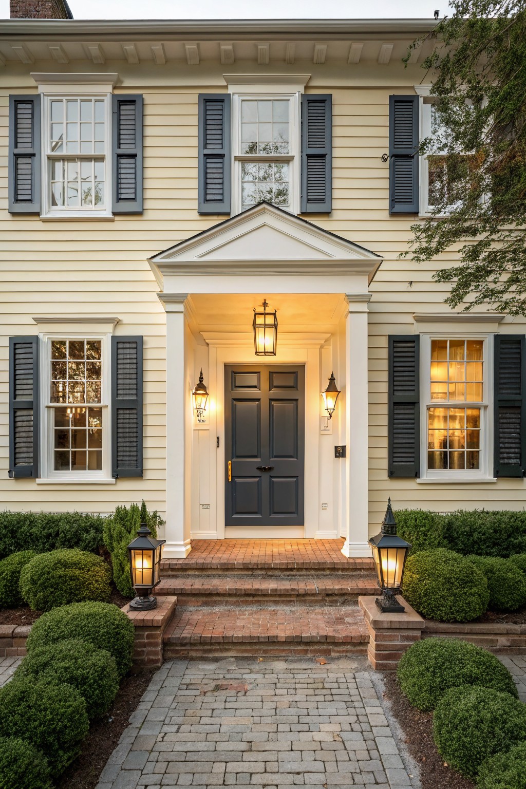 A house with light beige siding and a dark gray front door.