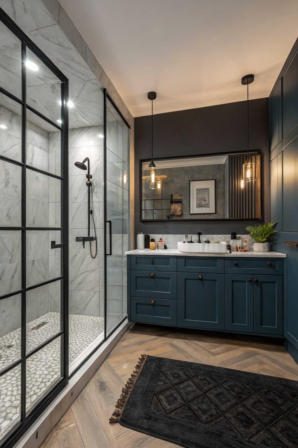 A bathroom featuring deep teal painted vanity cabinets beside a glass shower.