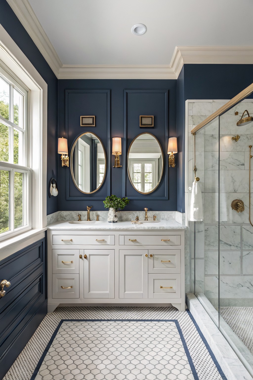 A bathroom with deep navy walls, white vanity, and marble accents.