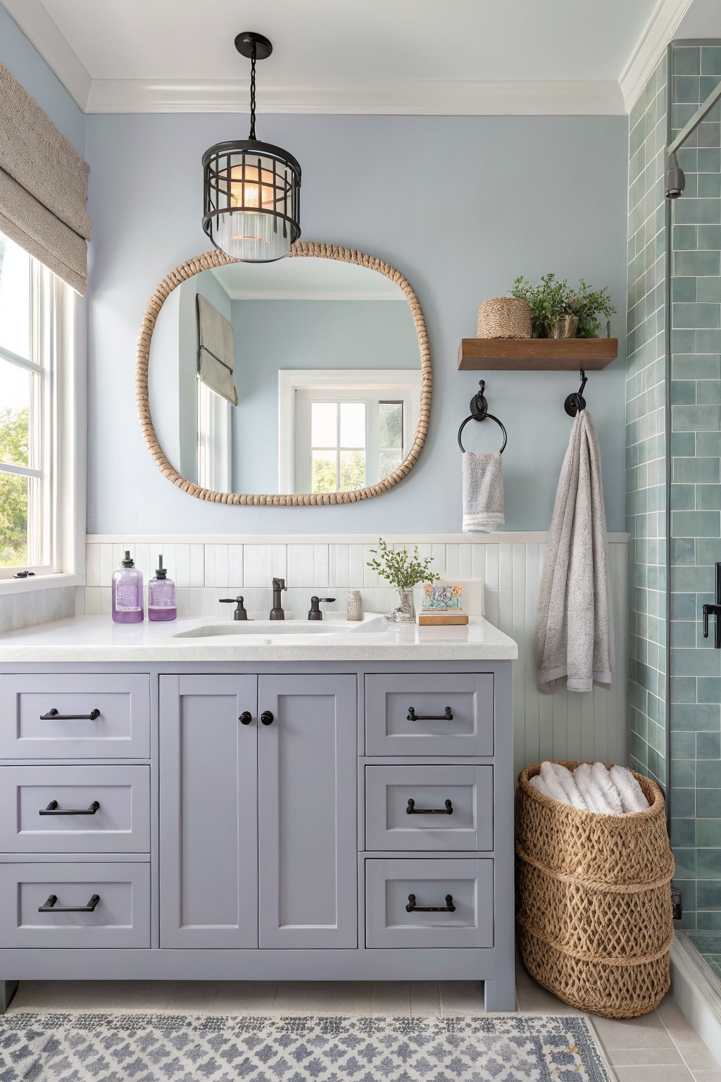 A bathroom with soft blue walls and a white vanity.