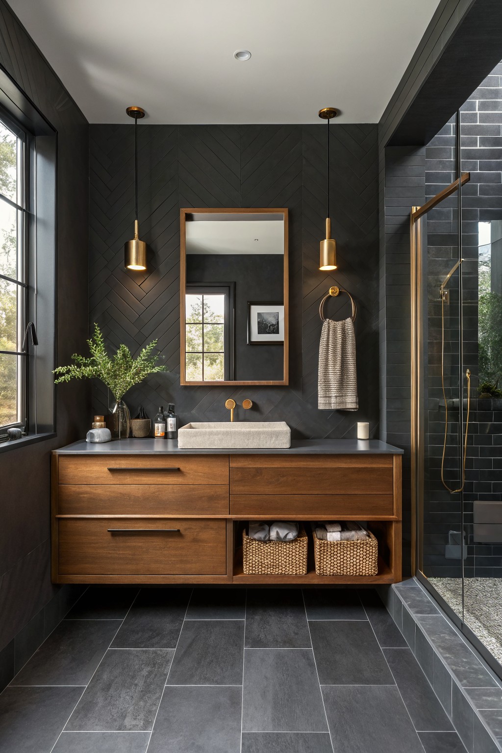 A modern bathroom with deep charcoal gray herringbone walls and a wood vanity.