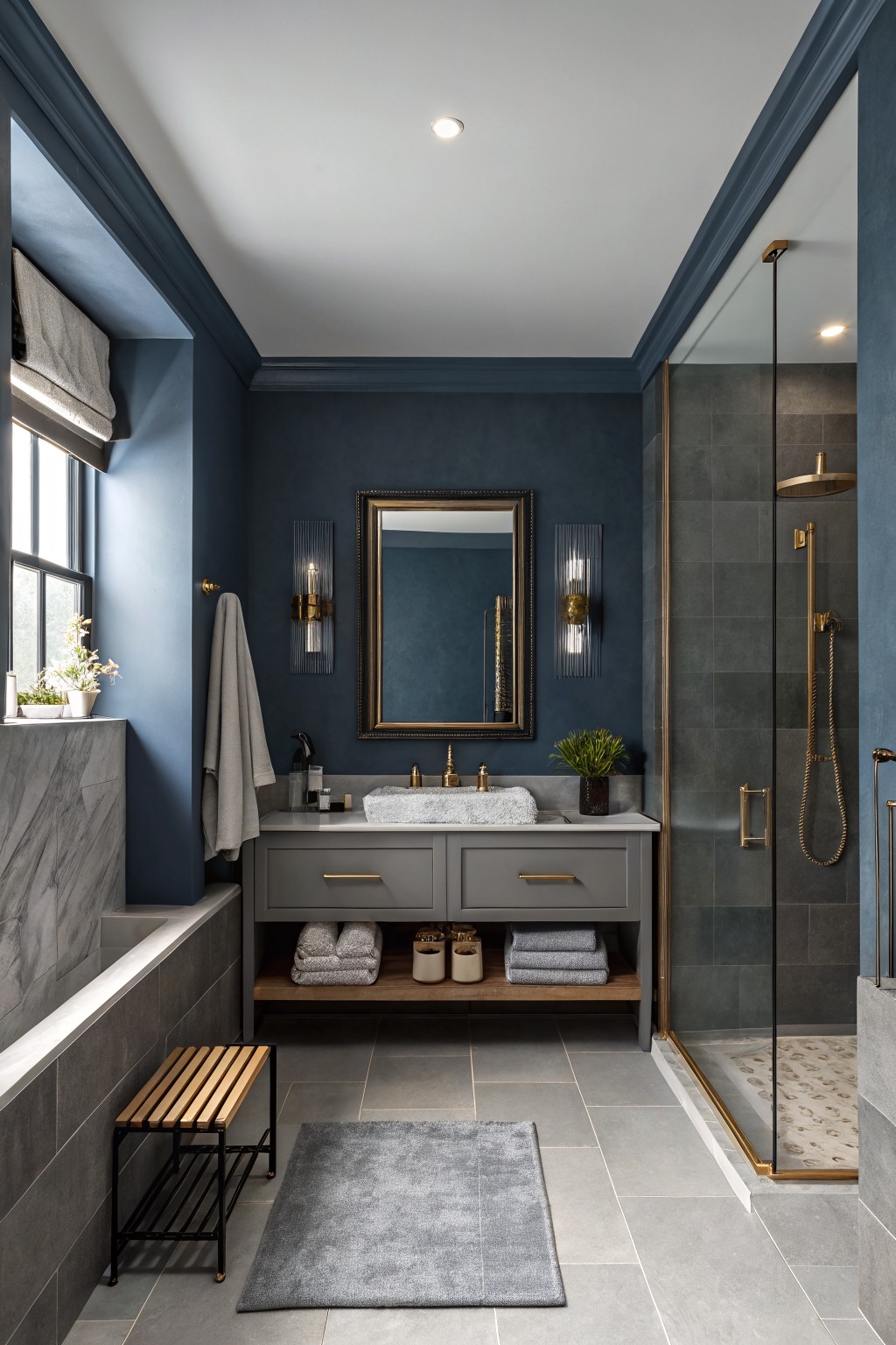 A bathroom with deep navy walls and a gray vanity.