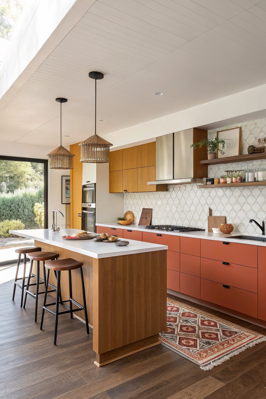 Terracotta kitchen cabinets with wood island and white countertops.