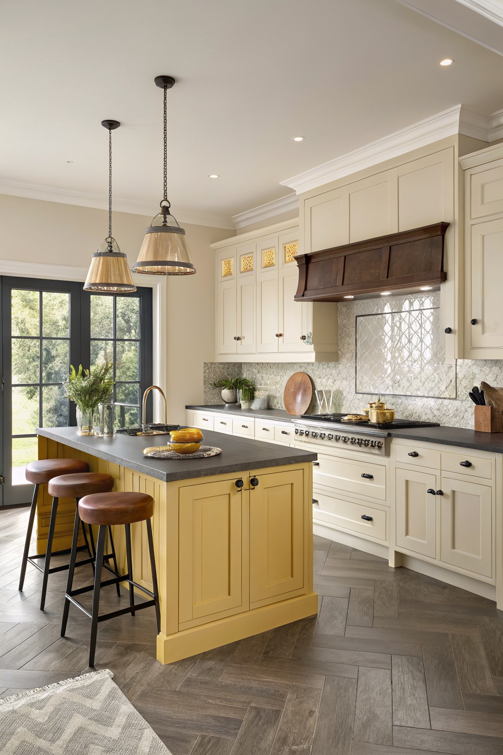 Kitchen with yellow island cabinets and cream perimeter cabinets.