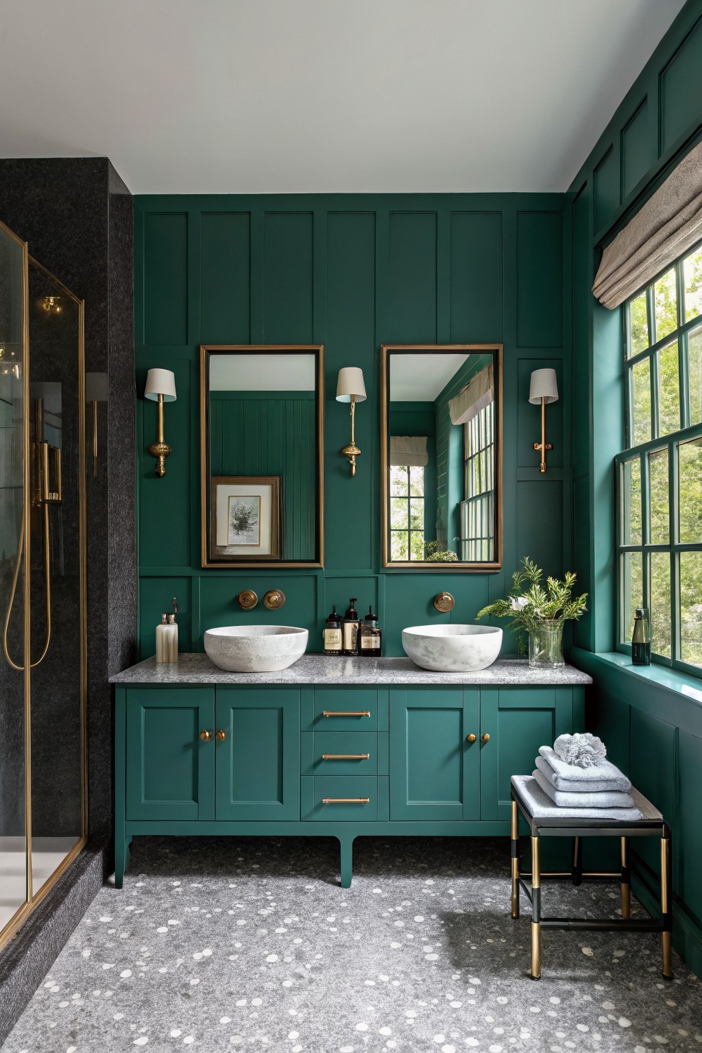 Emerald green bathroom with dual marble sinks, gold fixtures, and terrazzo floor.