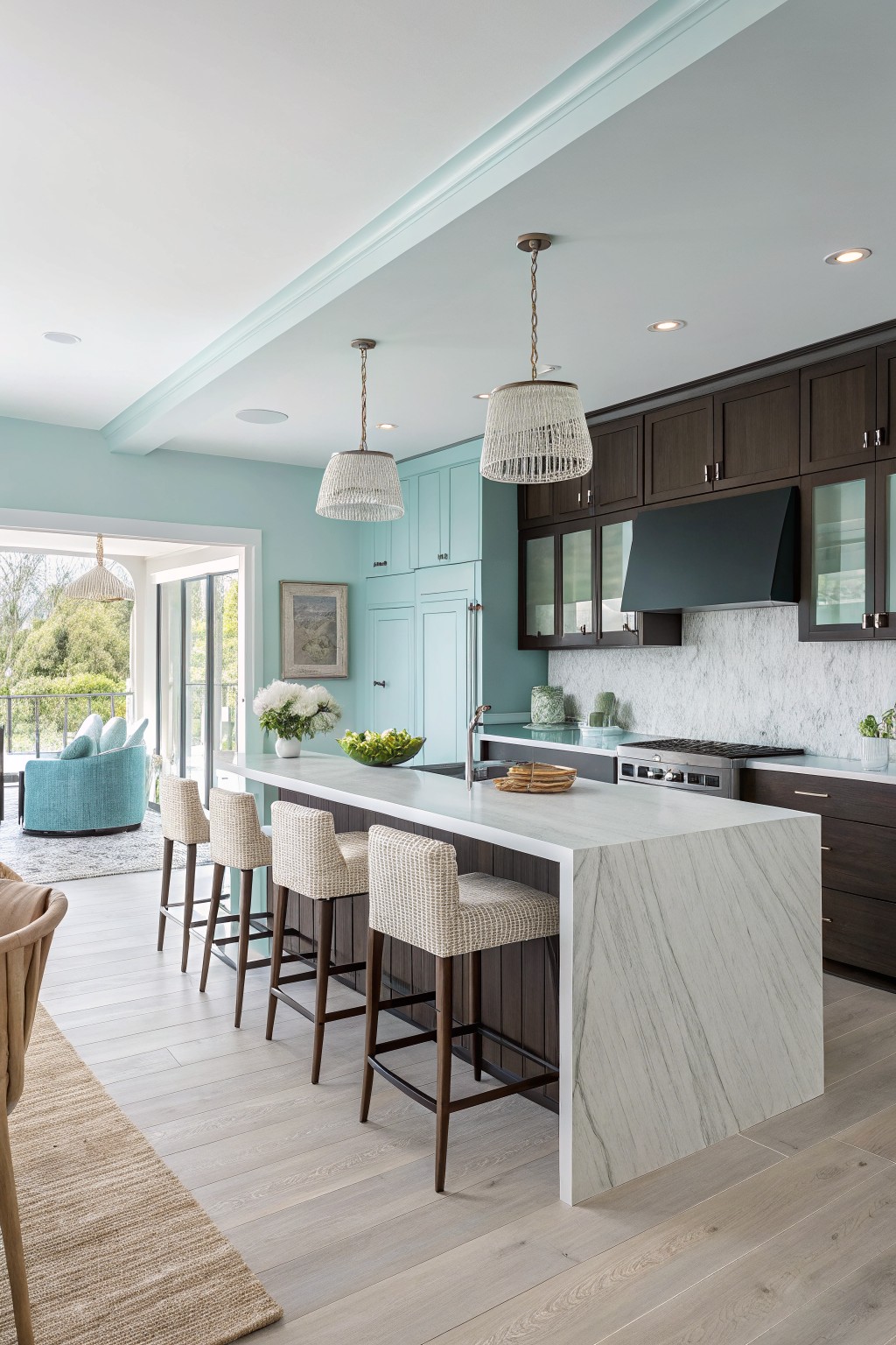 A kitchen with soft aqua walls paired with dark brown cabinets.