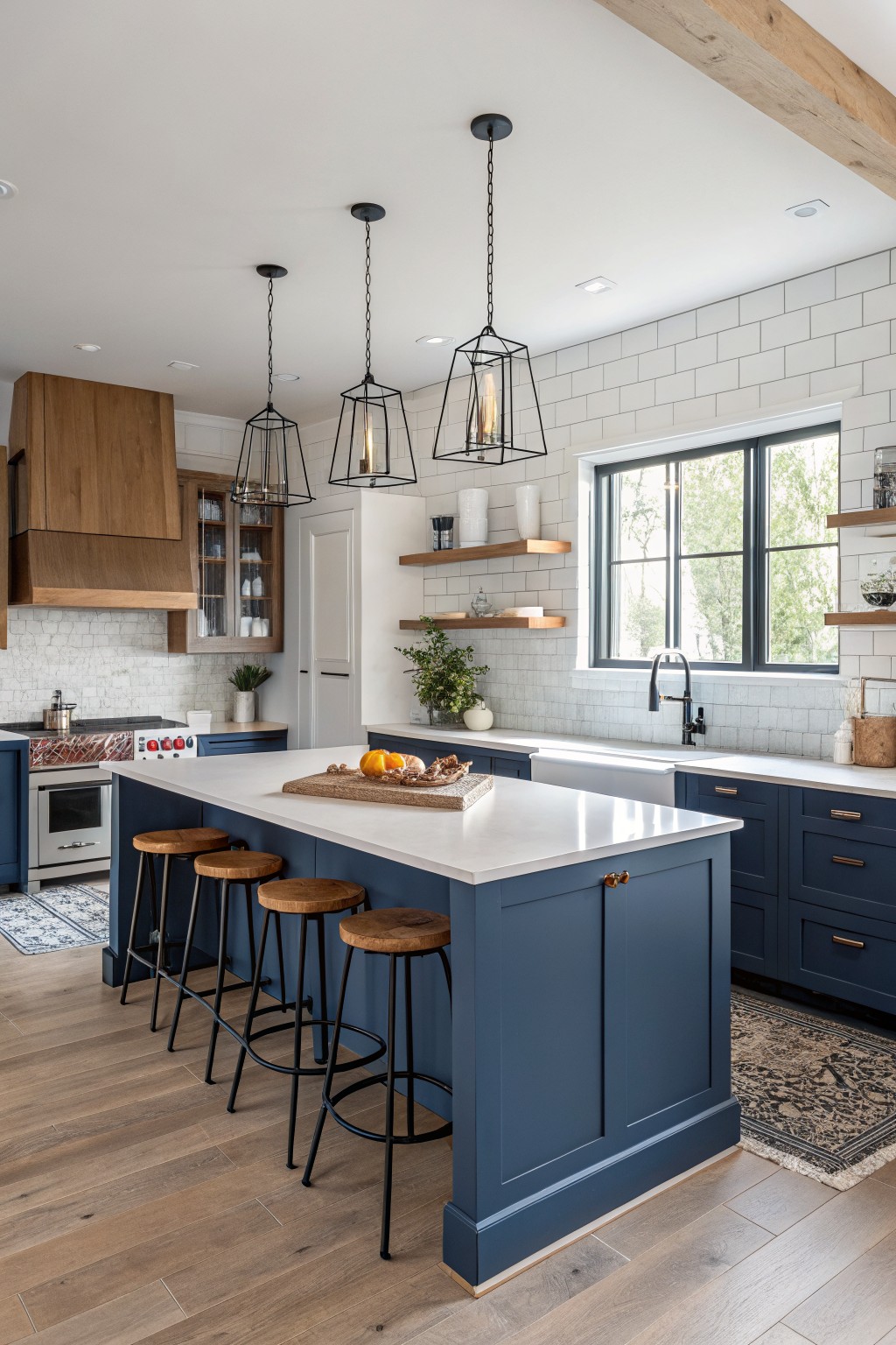 A kitchen island and cabinets painted in deep navy blue with white countertops.