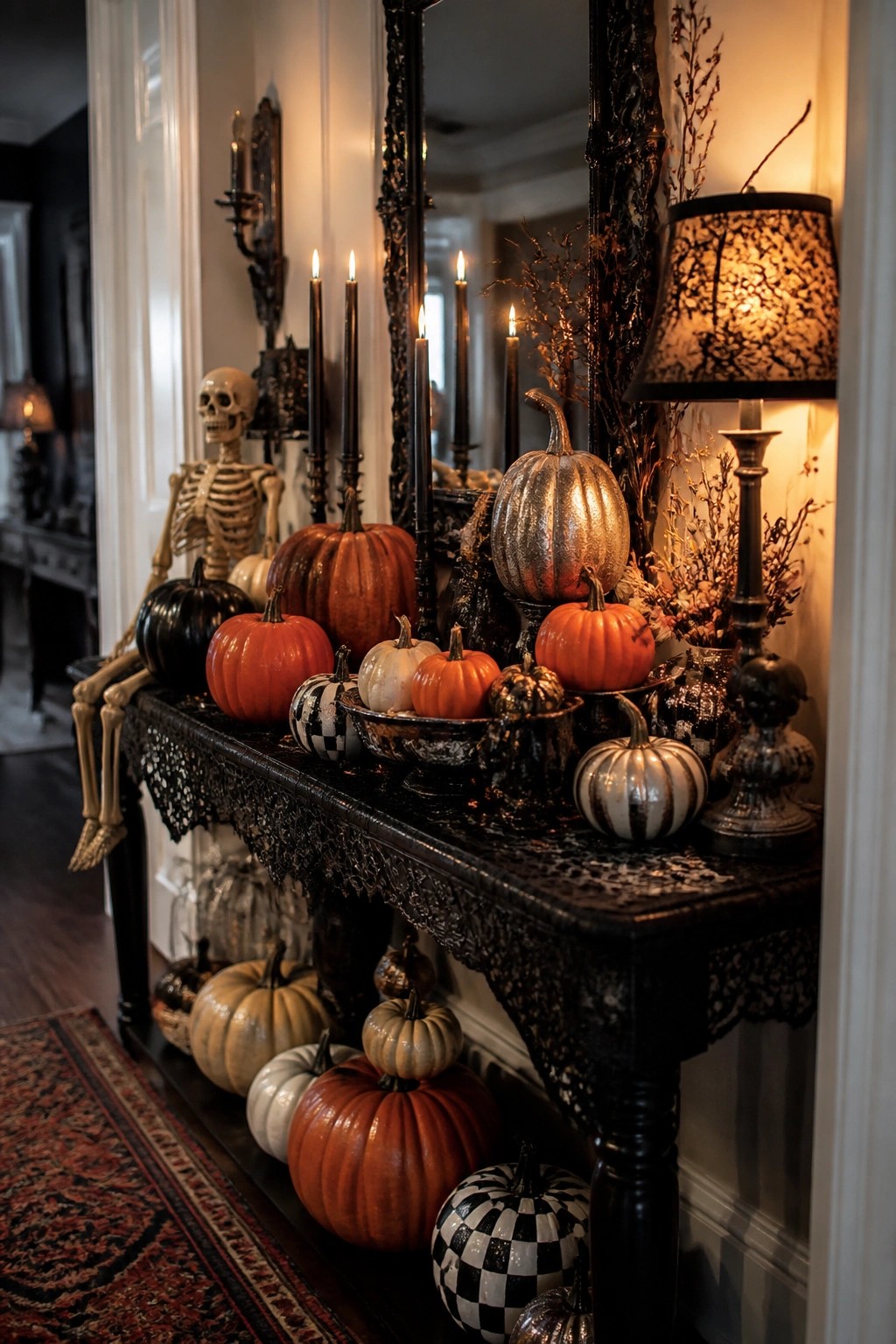 Ornate black table with pumpkins, skeleton, lit candles, and gothic decor.