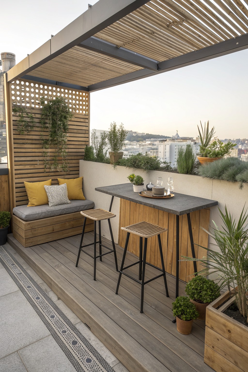 A rooftop terrace with a built-in wooden bench with cushions, two bar stools at a high counter, potted plants, and a slatted privacy screen.
